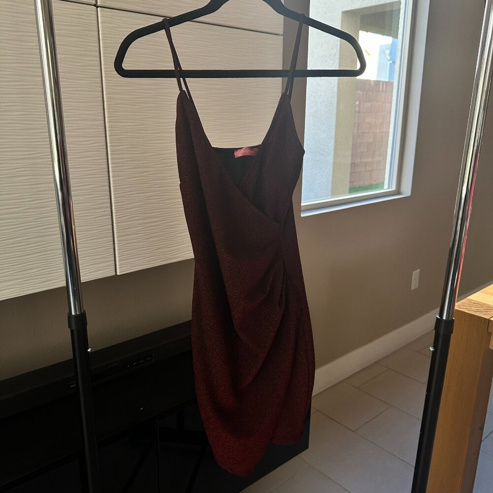 Black dress with red shimmer, sleeveless, asymmetrical.